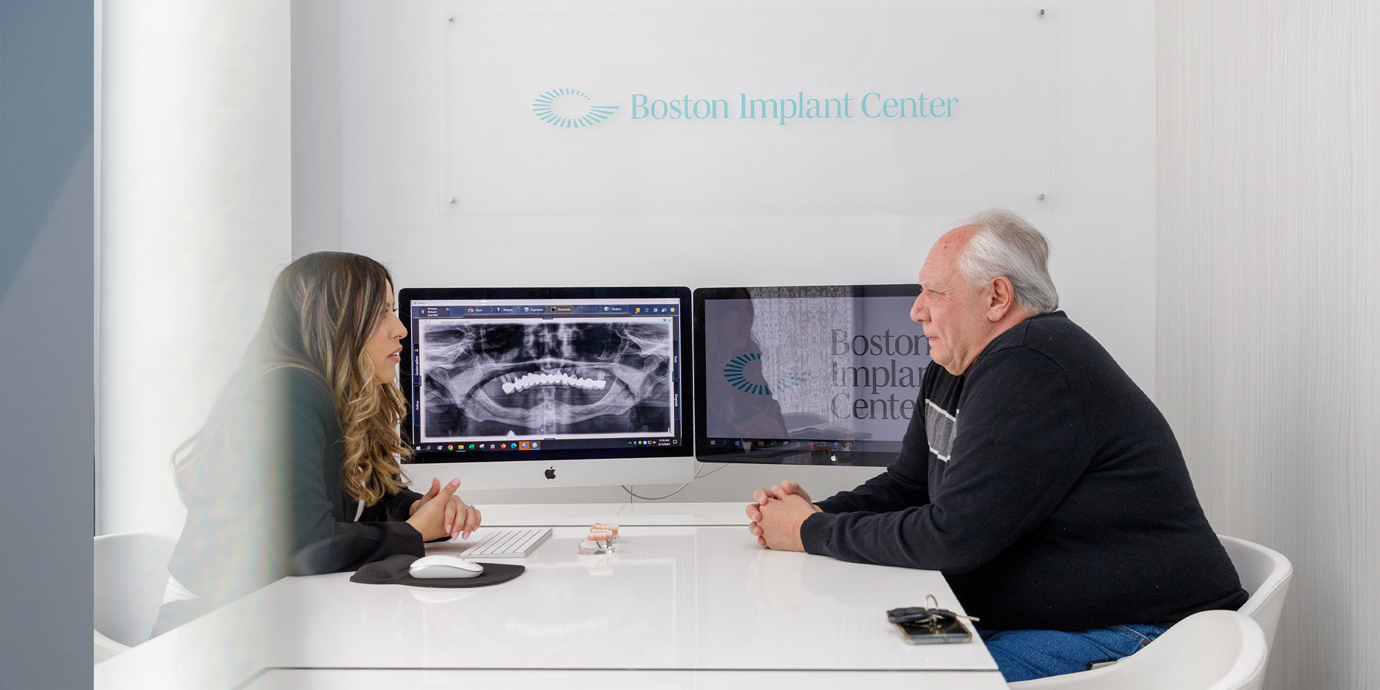 patient and staff member going over dental procedure information within the dental practice